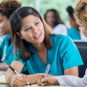 A nurse attentively listening to a patient in a healthcare setting.